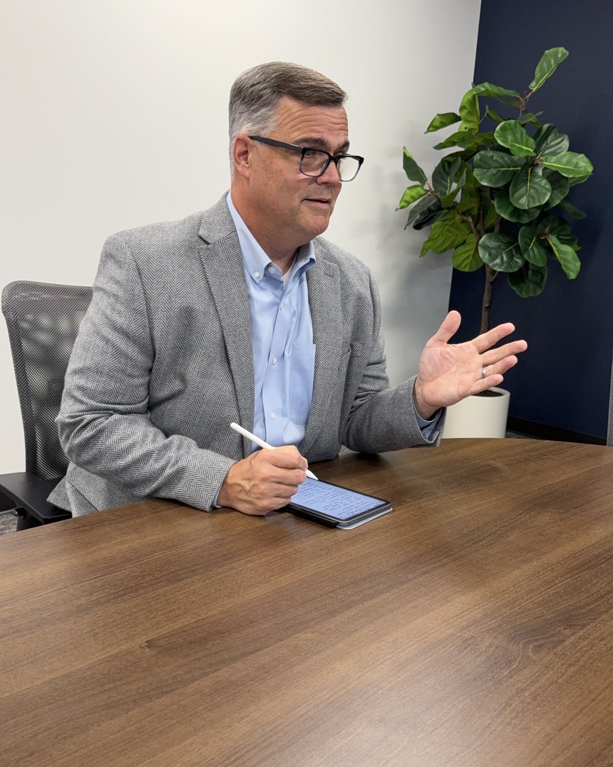 Brian Hanley listening and taking notes in a client meeting